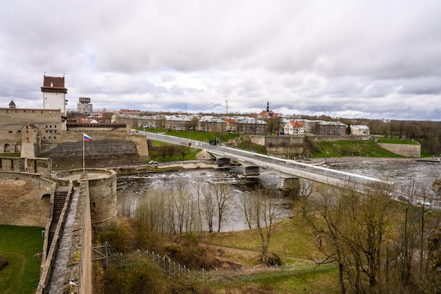 Old fortress walls Ivangorod fortress Old fortress walls Historical sites View from the fortress wall to Narva and the bridge that connects Russia and Estonia State border