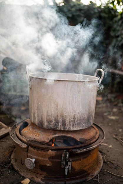 The old grandmother prepares potatoes for the cattle antithetical man cooking