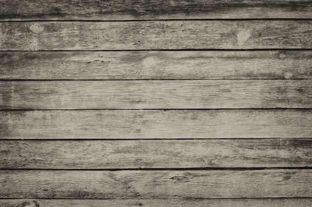 Old gray shabby wooden planks with cracked color paint