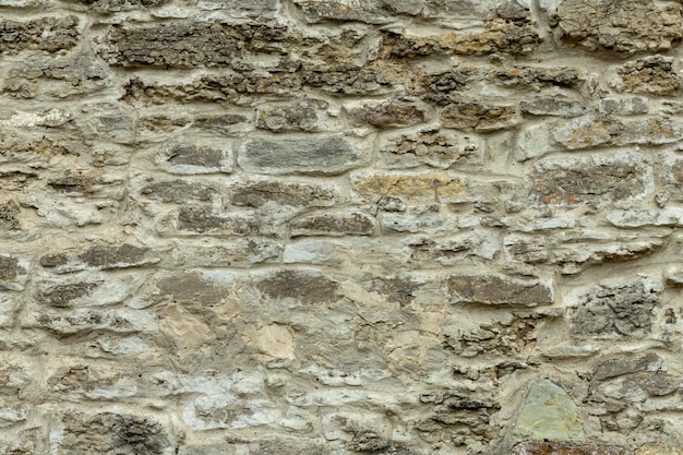 Old gray stone wall. Stone background from gray old stones.