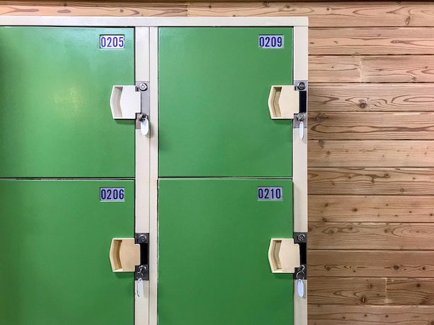 Old green locker cabinet with key in locker room