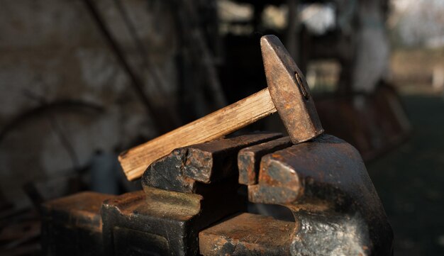 Old hammer on old metal vise