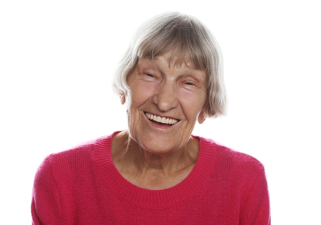 Old happy surprised woman over white wall, lifestyle concept