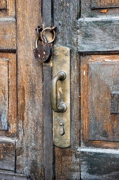 Old house door with brass handle a locked