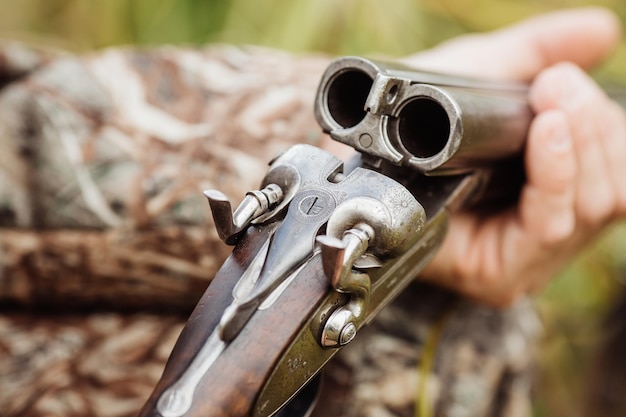 Old hunter loading his gun