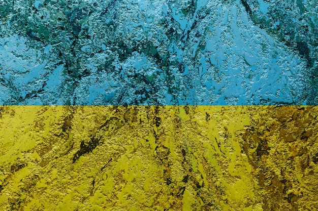 An old image of the flag of Ukraine on a wall with a crack A crisis