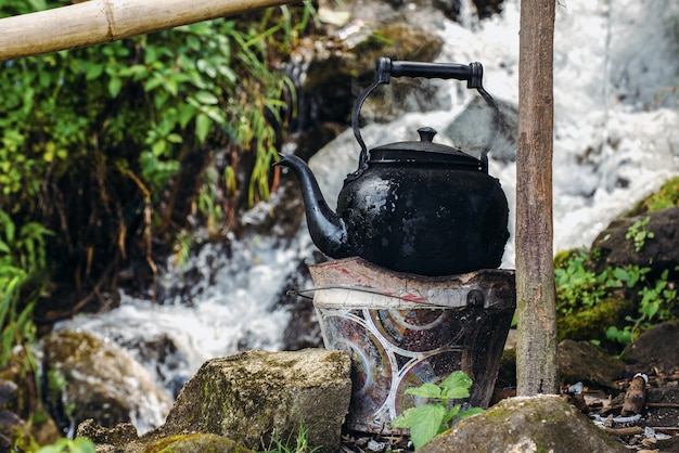 Old kettle on the fire at an outdoor in camping.