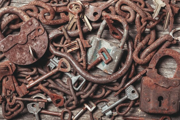 Old keys locks over vintage wooden table