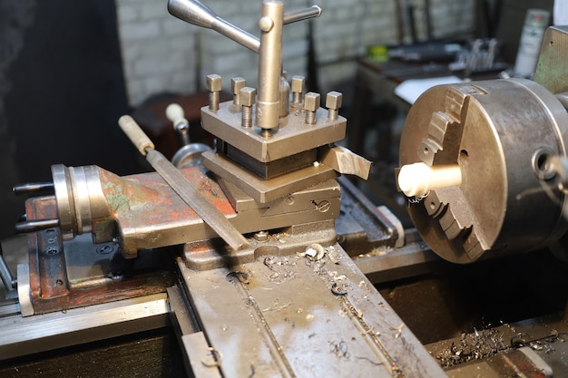 Old lathe machine close-up of a turner's workplace