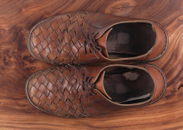 old leather brown shoes on wooden background