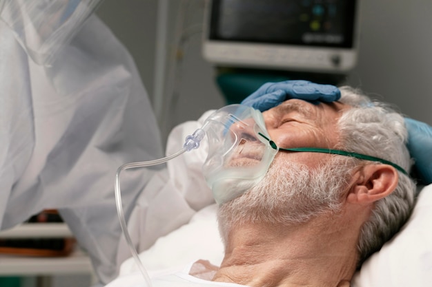 Old man breathing with a special equipment