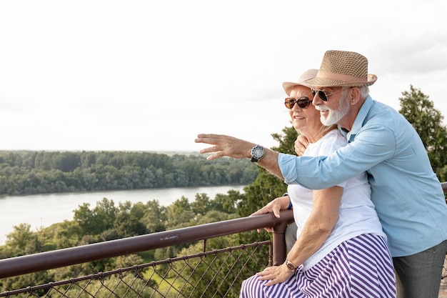 Old man pointing away to his woman