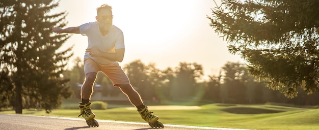 The old man in sunglasses rollerblading outdoor