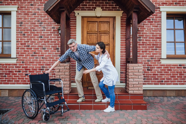 Old man want to sit at his wheechair near nursing home