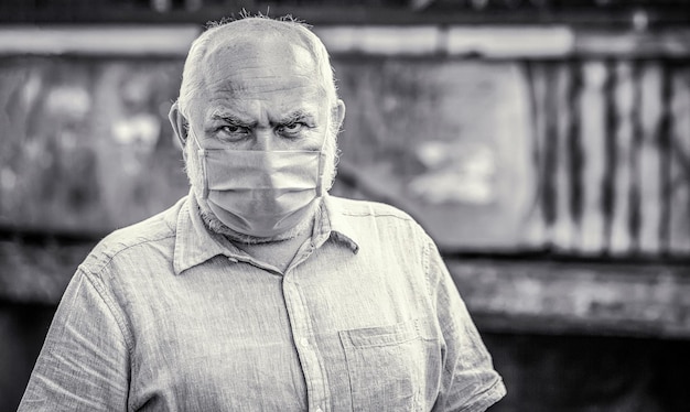 Old man wearing face mask Portrait of an old man years old in a medical mask Black and white