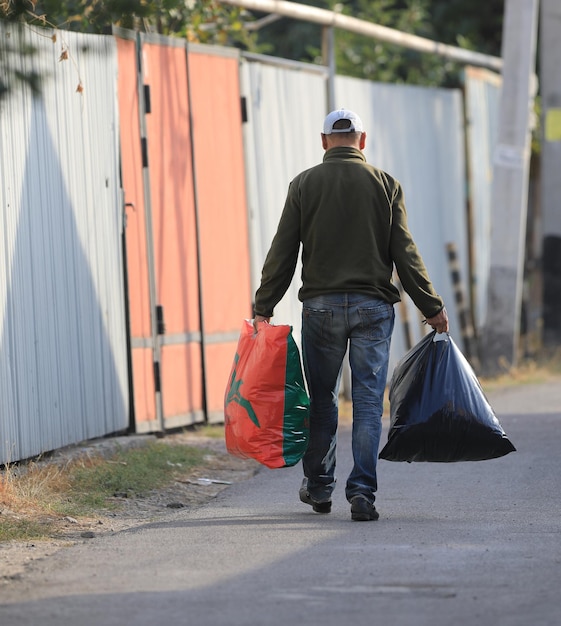 old man with bags on the street