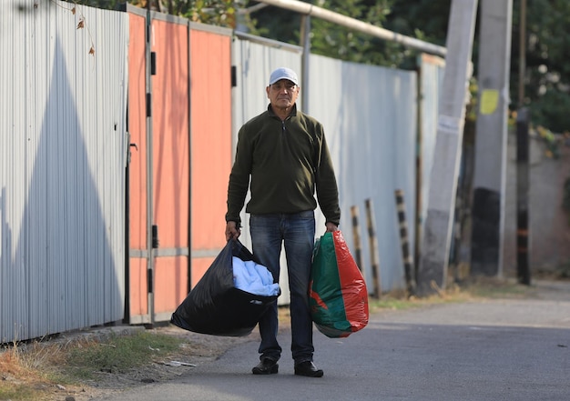 old man with bags on the street