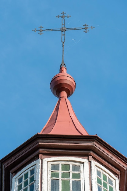 An old metal cross on the dome of a Christian church An old wooden church Celebration of Christian holidays baptism and communion in the church