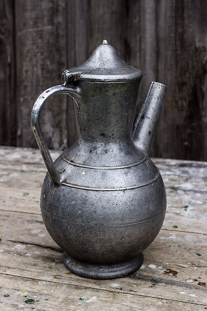 Old metal pitcher on a table