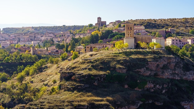 Old mountain village above the ravine on a sunny fall day. Sepulveda, Segovia.