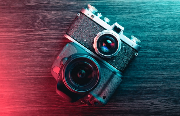 Old and new camera. Concept of technology progress. Blue and red light