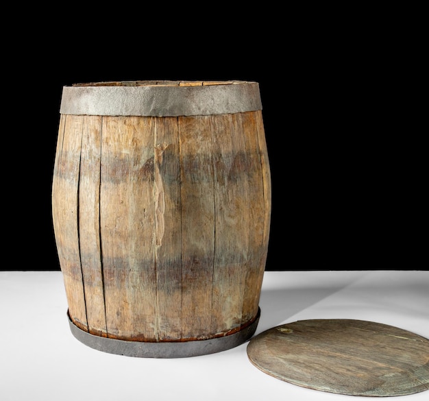 Old oak barrel for wine on a black background