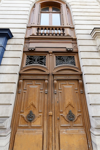 Old ornate door in paris france typical old apartment building