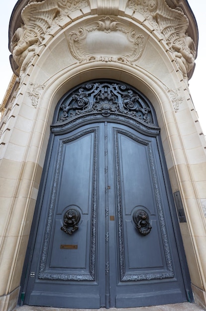 Old ornate door in paris france typical old apartment building