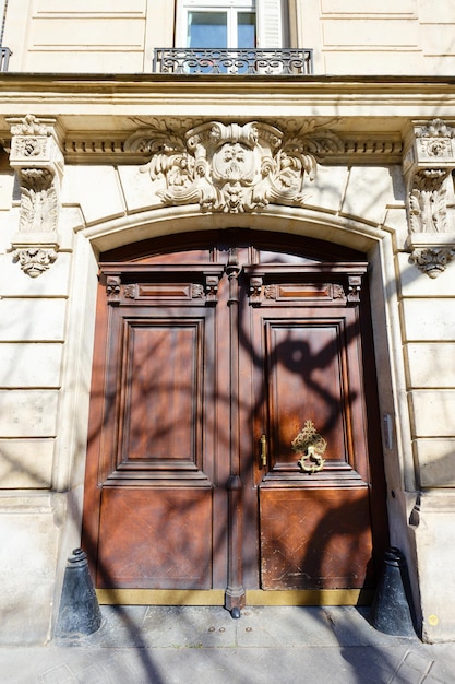 Old ornate door in paris france typical old apartment building