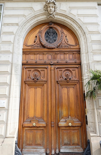 Old ornate door in Paris typical old apartment buildiing