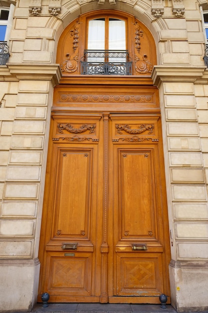 Old ornate door in Paris typical old apartment buildiing