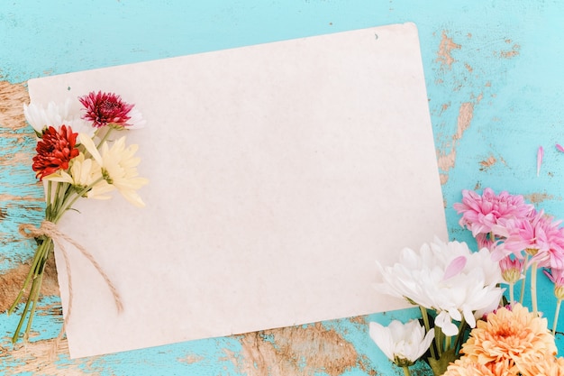 Old paper with flowers on vintage wood background