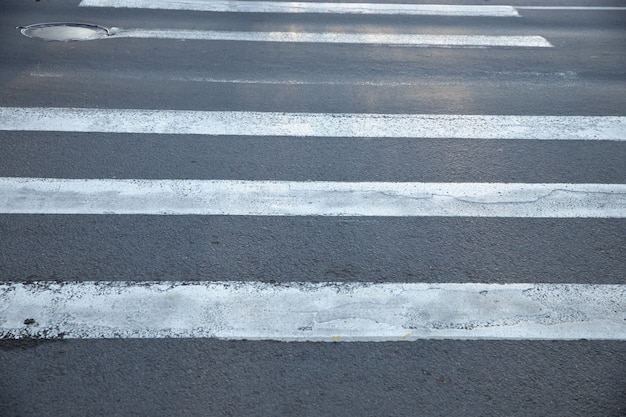 Old pedestrian crossing over an asphalt road