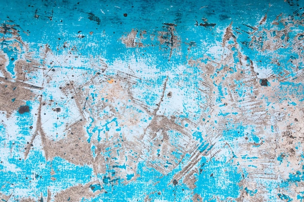 Old peeling paint on old blue concrete wall backgroundGrunge blue wall background or texture