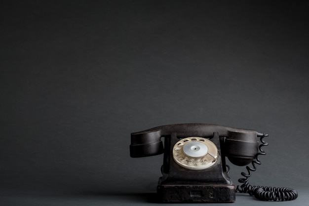 A old phone on the black background