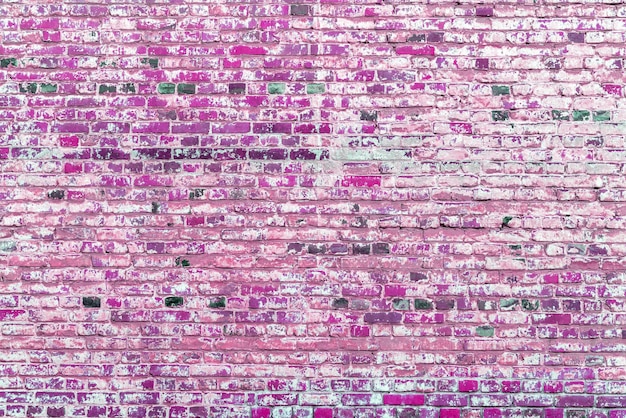 Old pink brick wall Peeling white paint on a pink wall