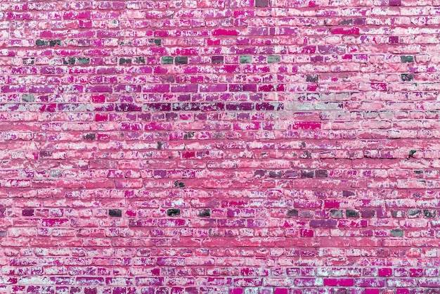 Old pink brick wall Peeling white paint on a pink wall