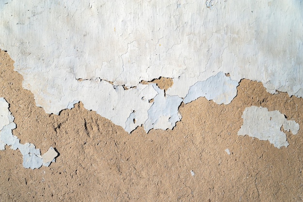 Old plastered wall background Texture old peeling potreskanoy weathered plaster chipped and cracked