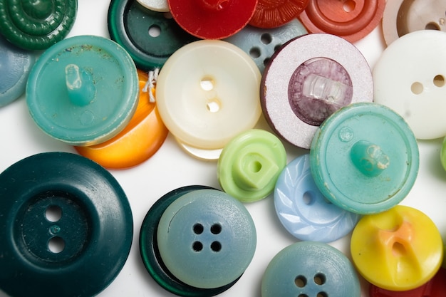 Old plastic buttons in different colors on the background. tinting