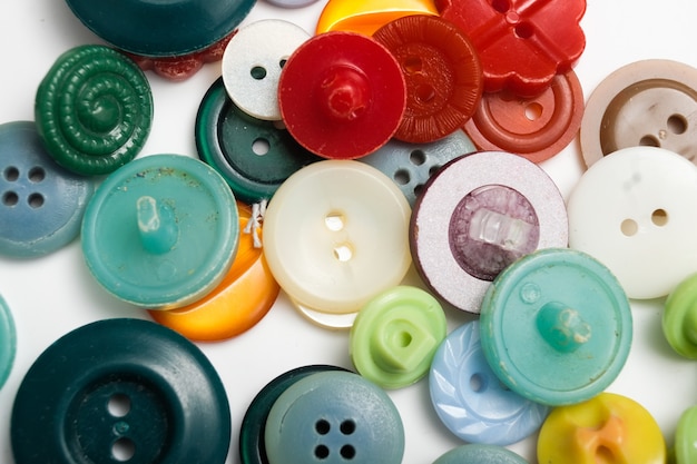 Old plastic buttons in different colors on the background. tinting