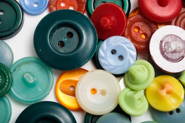 Old plastic buttons in different colors on the background. tinting