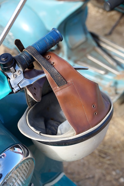 An old plastic helmet on a retro a motor scooter