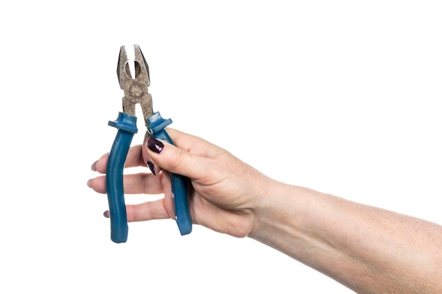 Photo old pliers in female hand with manicure isolated on white background