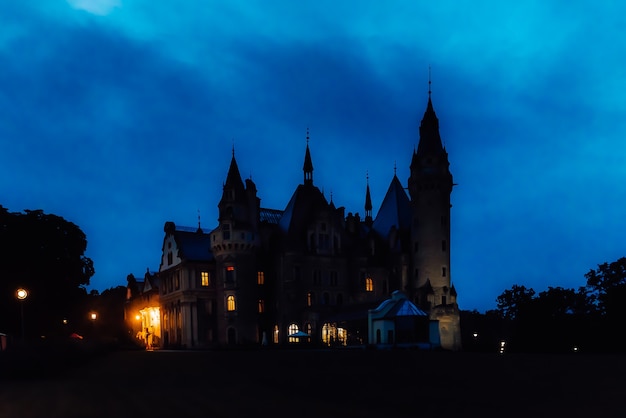 Old Polish castle in the village of moszna in the night lights