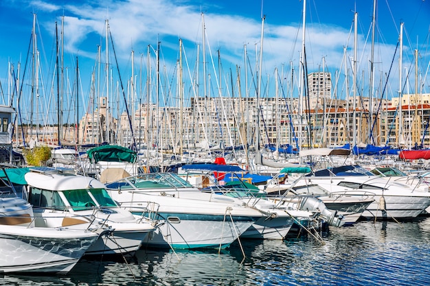 Old port with moored yachts in Marseille on a bright sunny day.