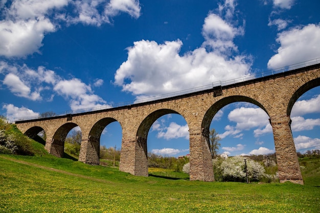 Old railway stone viaduct in the spring in sunny day