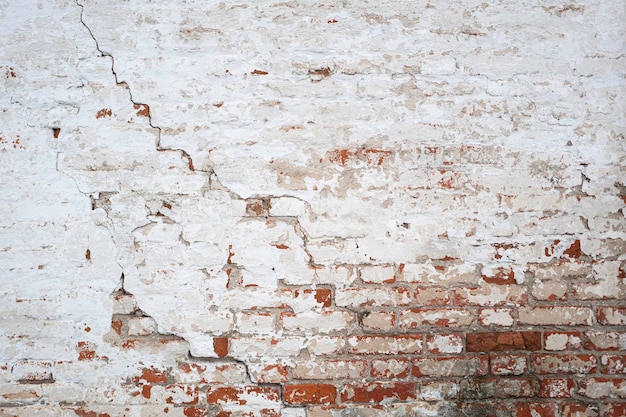 Old red brick wall with cracks as a background