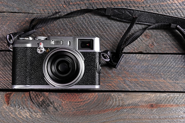 Old retro camera on rustic wooden planks background