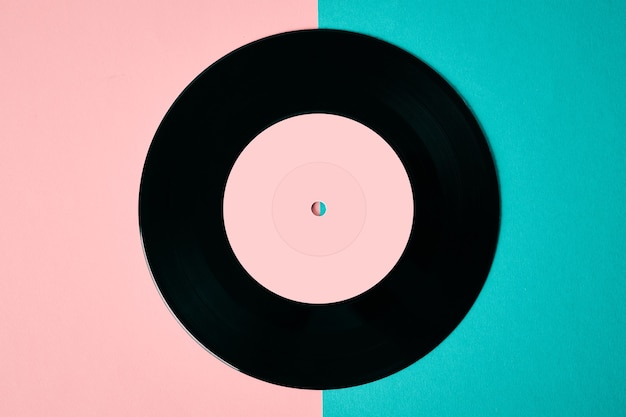 Old retro vinyl disc on colored background