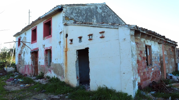 Old ruined abandoned stone house close-up, broken dilapidated housing